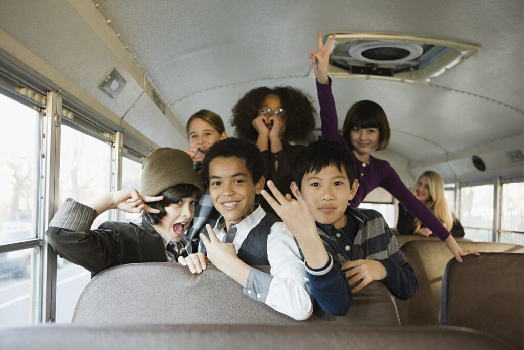 Kids enjoying a fun ride on a school bus
